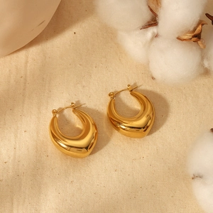 Polished 18k gold plated hollow teardrop earrings on a natural linen background