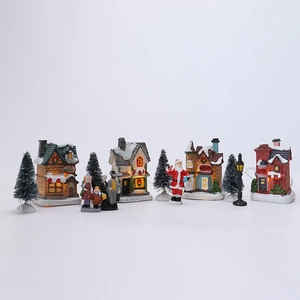Set de aldea navideña luminosa de 11 piezas con figuritas y pinos nevados de resina