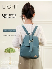 Detail of teal leather backpack with gold buckle closure and kangaroo logo emblem