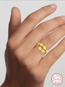Detailed view of sterling silver gold floral ring featuring delicate flower clusters