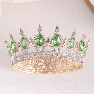 Detail of baroque bridal crown with green teardrop gems and sparkling crystals on gold metal