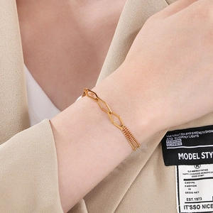 Gold stainless steel geometric linkage chain bracelet with OT clasp worn on wrist
