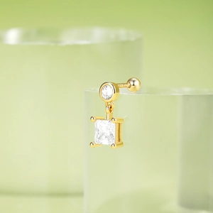 Macro detail of S925 silver gold-plated square zircon stud earring with polished finish
