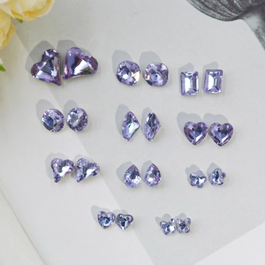 Lavender K9 crystal nail art rhinestones in various faceted shapes on a white background