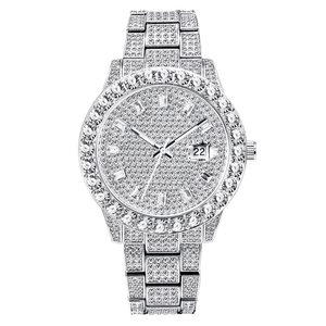 Macro shot of silver hip hop watch featuring full rhinestone-encrusted dial and date window