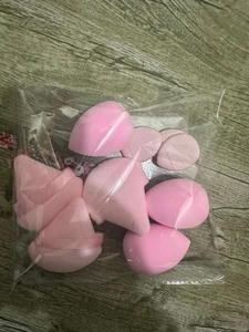 Macro shot of 12-piece pink makeup sponge set in teardrop and cut shapes