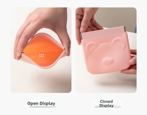 Pink bear silicone pouch showing squeeze-to-open function and orange lining detail