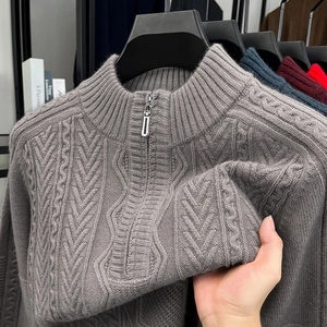 Detailed view of grey cable knit texture and half-zip stand collar on men's winter sweater