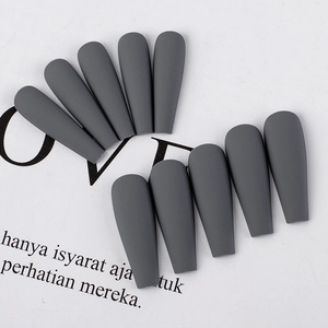 Macro shot of 10 matte grey ballerina style press-on nails arranged on a white background