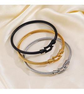 Detailed macro view of three-color twisted cable bracelets with horse shoe clasps