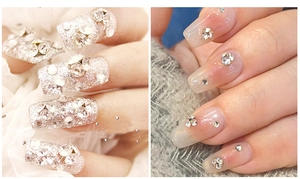 Detail of glitter nail art with clear rhinestones and minimalist crystal designs