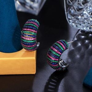 Macro shot of colorful gradient zircon stones on C-shape earrings with black plating