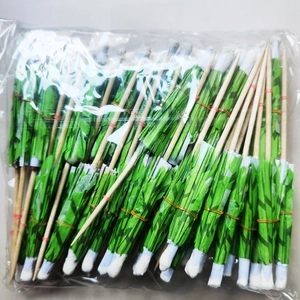 Bulk pack of disposable green palm tree cocktail picks for tropical party decorations