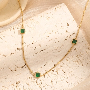 Elegant gold titanium necklace with square green zircons and small gold beads