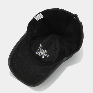 Detail of cute cat embroidery and 100% cotton label inside the black washed baseball cap