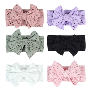 Detail view of 6-pack baby bow headbands featuring eyelet hollow patterns in multi-colors