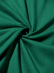 Detailed macro view of forest green cotton fabric texture and soft knit material