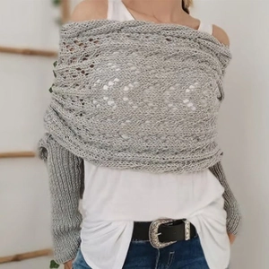 Grey knit shawl scarf with hollow pattern design worn by a model in casual style