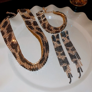 Detailed view of leopard print rhinestone necklace, bracelet and earrings jewelry set