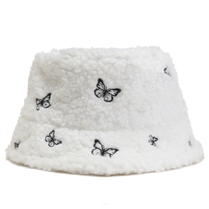 White sherpa bucket hat with black butterfly embroidery for women's winter outdoor wear