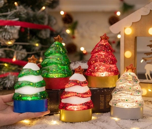 Set of five mini glowing resin Christmas trees with LED light bases and sparkling glitter