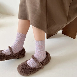 Pink gradient wool knit socks with speckled texture paired with brown Mary Jane shoes