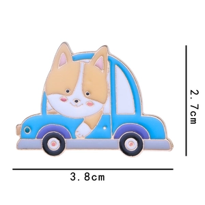 Cartoon corgi driving a blue car enamel brooch badge measures 3.8cm wide by 2.7cm high