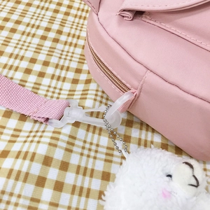 Cute pink canvas crossbody bag with white plush bear charm for teen girls