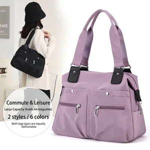 Large lavender nylon tote bag with functional exterior zip pockets and shoulder straps