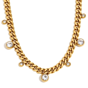 Golden Cuban link necklace with round cubic zirconia pendants on white background