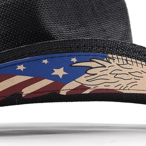 Detailed view of black woven cowboy hat featuring patriotic eagle and flag patterned band