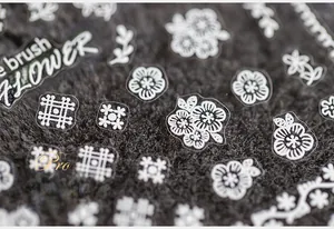 Macro detail of ultra-thin white flower nail stickers with precise floral patterns