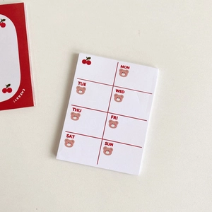 Detailed view of weekly memo pad with cute cherry bear design and daily grid layout