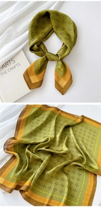 Close-up of olive green silk scarf featuring retro geometric patterns and satin texture