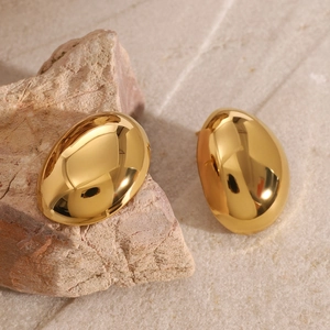 Polished 18k gold oval egg-shaped stud earrings on natural stone for a luxury look