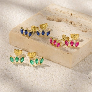 Detailed macro view of marquise cut zircon stud earrings in blue, pink, and emerald green