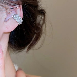 Close-up of silver ear bone clip with micro-paved sparkling round-cut zircon stones