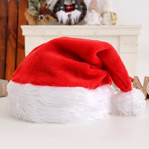 Classic red plush Christmas hat with white faux fur trim and pompom for festive party decor