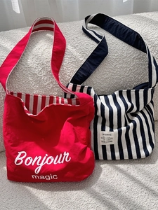 Canvas tote bags in red and blue-white stripes with minimalist letter prints and label