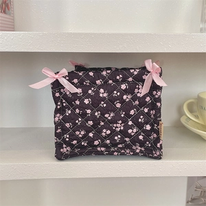 Quilted floral storage basket with pink satin bows and decorative side ribbon detail