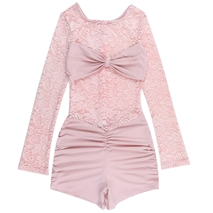 Close-up of pink floral lace stitching and large bow on the long-sleeve bodysuit