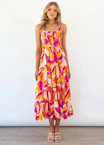 Detail of tiered long dress featuring vibrant pink and orange floral print patterns