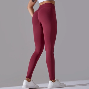 Close-up of seamless burgundy high-waisted yoga pants with peach lift effect for fitness