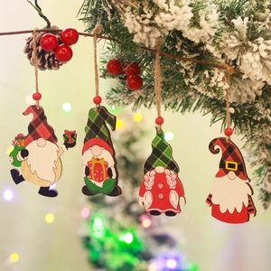 Set of 4 festive wooden Christmas gnome ornaments hanging on a snowy tree branch