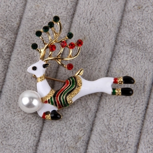Macro shot of reindeer brooch with enamel, sparkling rhinestones and a large pearl