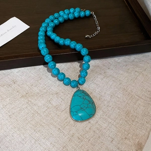 Bohemian turquoise teardrop pendant necklace with black crackle texture on vintage beads