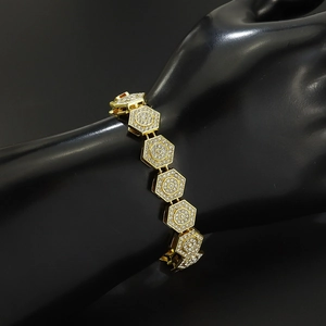 Macro shot of gold geometric hexagonal links with full pave crystals on a black display