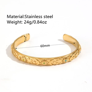 Gold plated stainless steel open bangle with embossed sun moon star and zircon stones