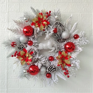 Frosted Christmas wreath with silver reindeer, red gold flowers, pinecones and ornaments
