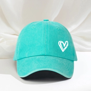 Adjustable mint green washed cotton baseball cap featuring a white embroidered heart